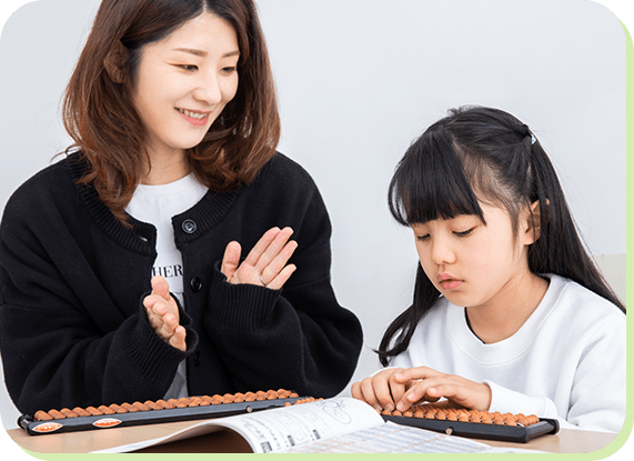 そろばんを教わる女の子
